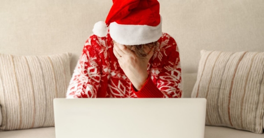 stressed woman looking at computer at Christmas
