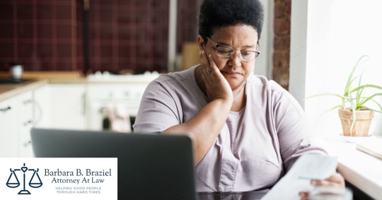 Woman looking upset at bills and debt