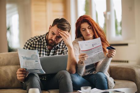 a man and woman looking at papers